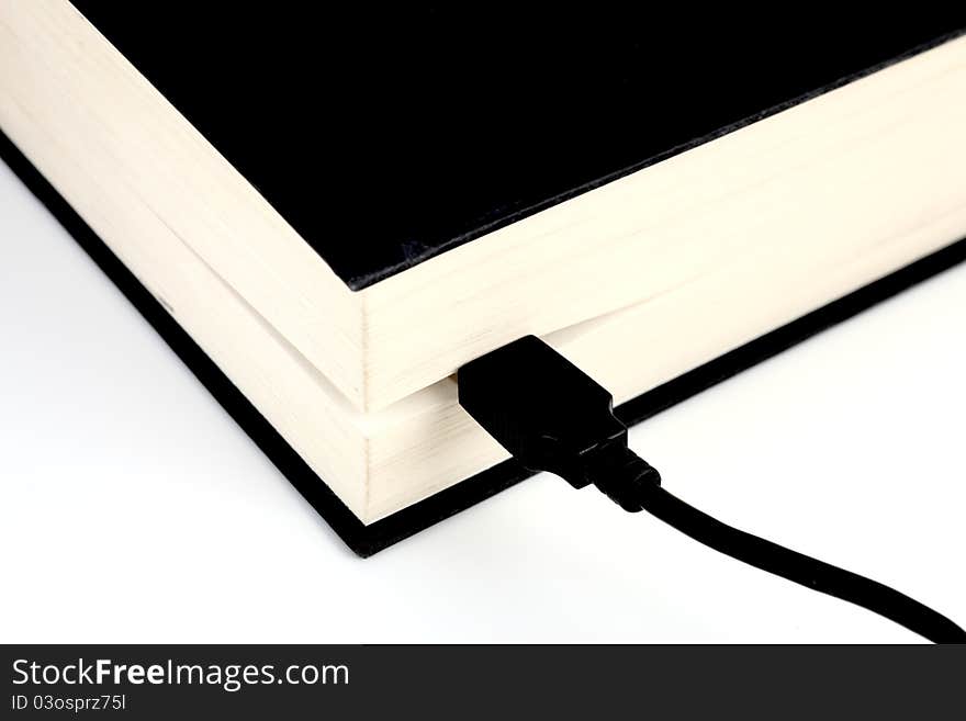 USB cable connected to a book. USB cable connected to a book