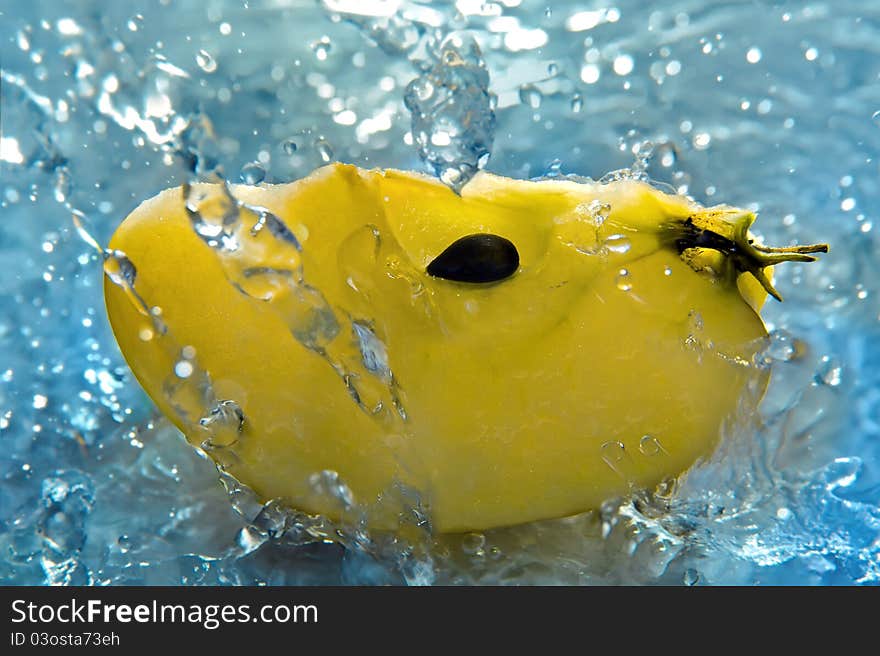 Apple in water flow, blue background. Apple in water flow, blue background