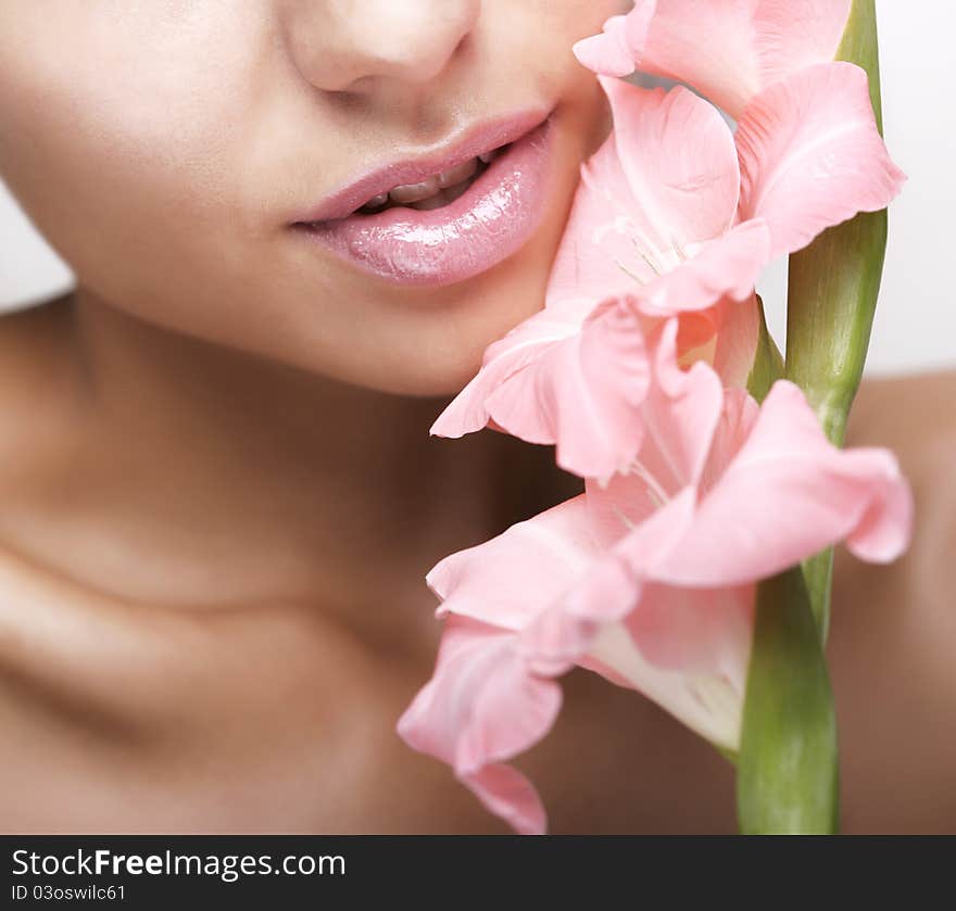 Beautiful women with flower and cosmetic cream