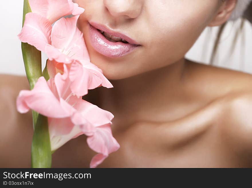 Beautiful women with flower and cosmetic cream