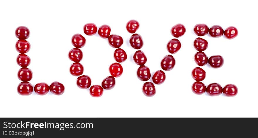 Love written of fresh cherries on white background. Love written of fresh cherries on white background