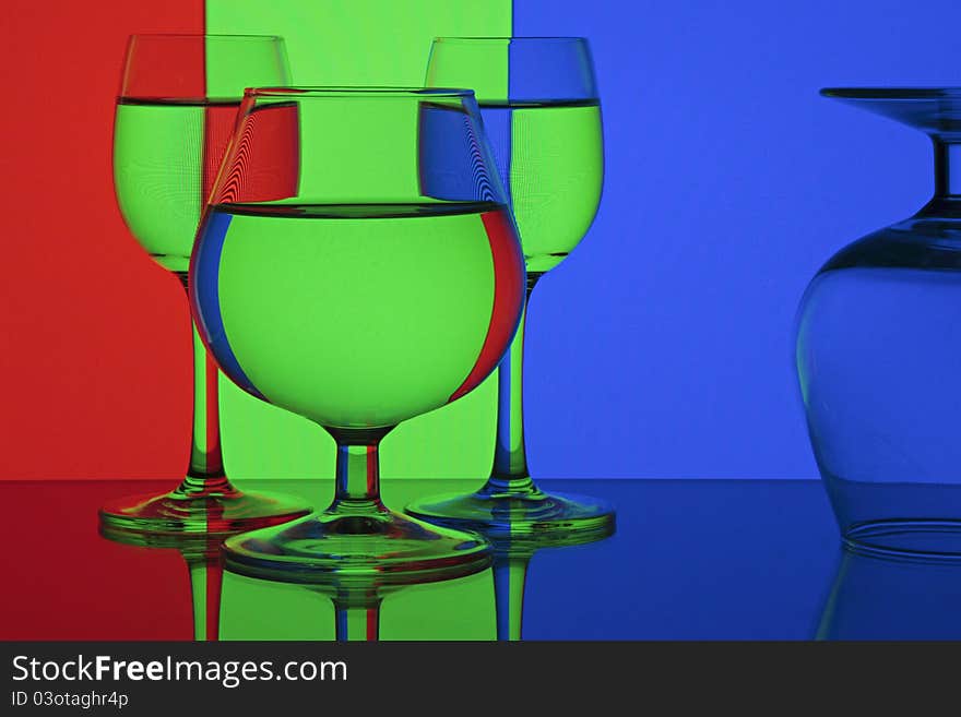 Abstraction - RGB (red, green, blue). Glasses on colorful background.