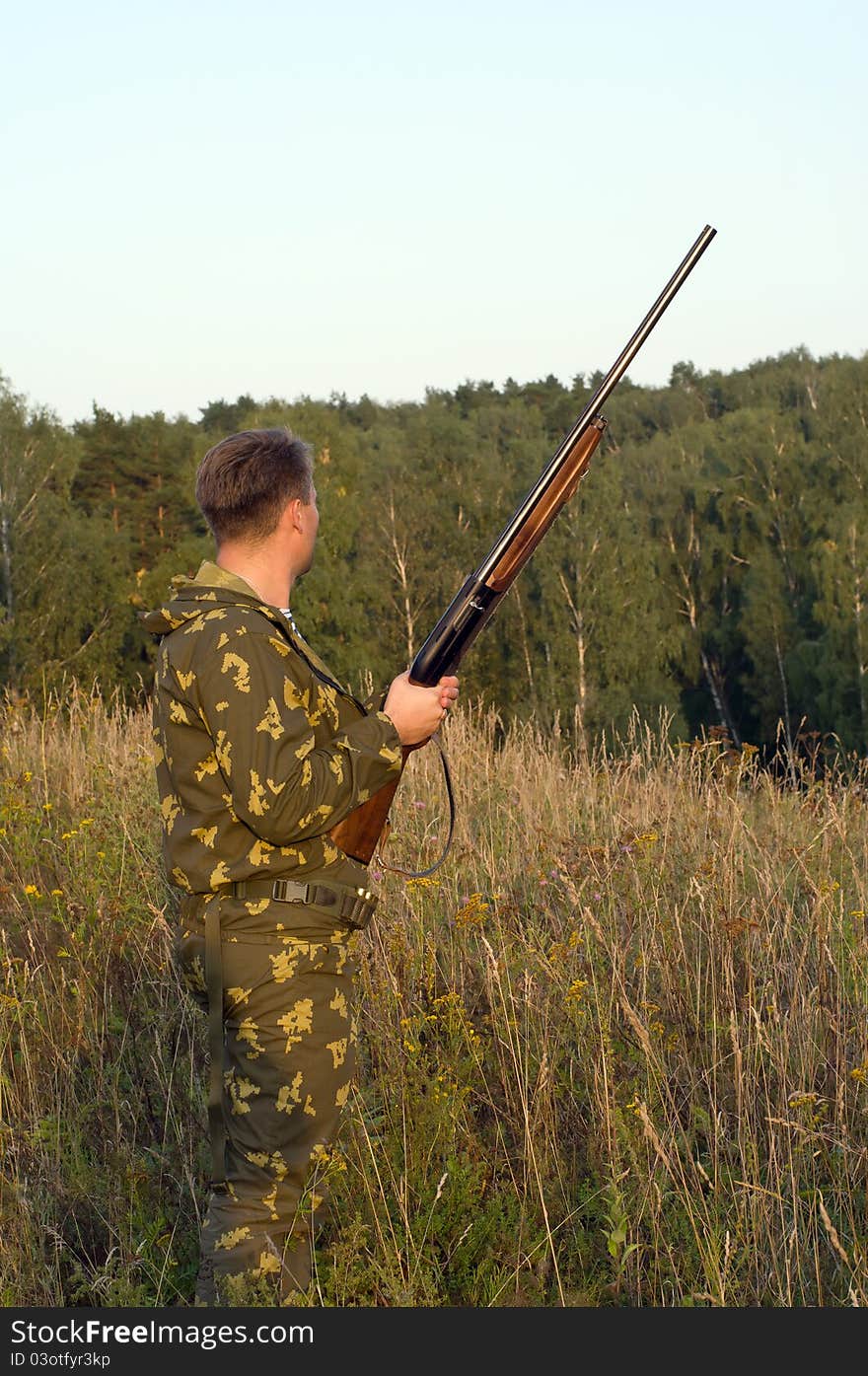 Outdoor shoot of man in camouflage with a shotgun. Outdoor shoot of man in camouflage with a shotgun.