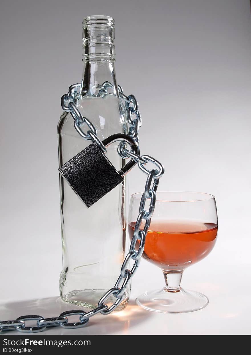 Color photo of bottles of whiskey and metal chain. Color photo of bottles of whiskey and metal chain