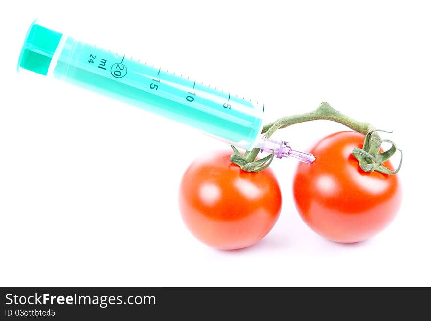 Tomatoes and syringe isolated of a white background. Tomatoes and syringe isolated of a white background