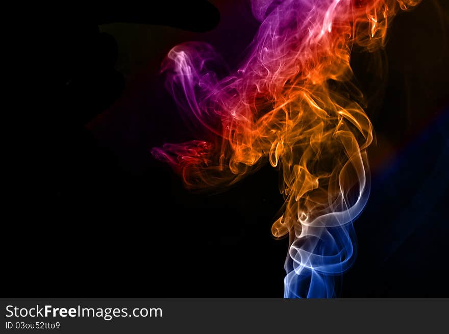 Colorful smoke abstract curly on black background