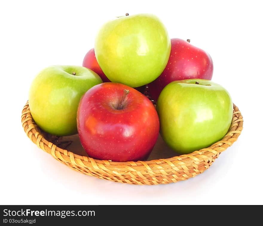 Apples on a wicker dish.