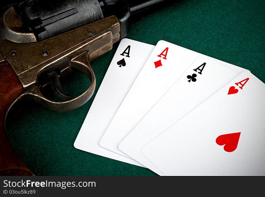 Four aces on table and old colt. Four aces on table and old colt