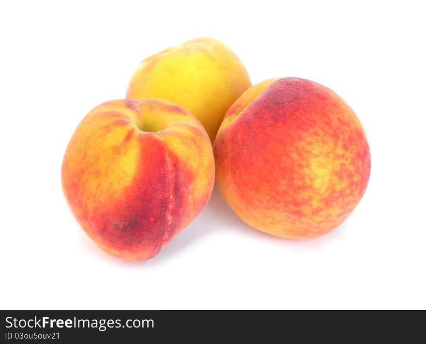 Ripe peaches on a white background are shown in the picture. Ripe peaches on a white background are shown in the picture.