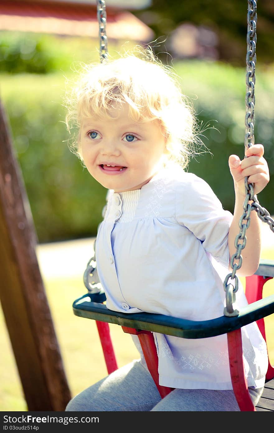 Little girl on a swing having a fun