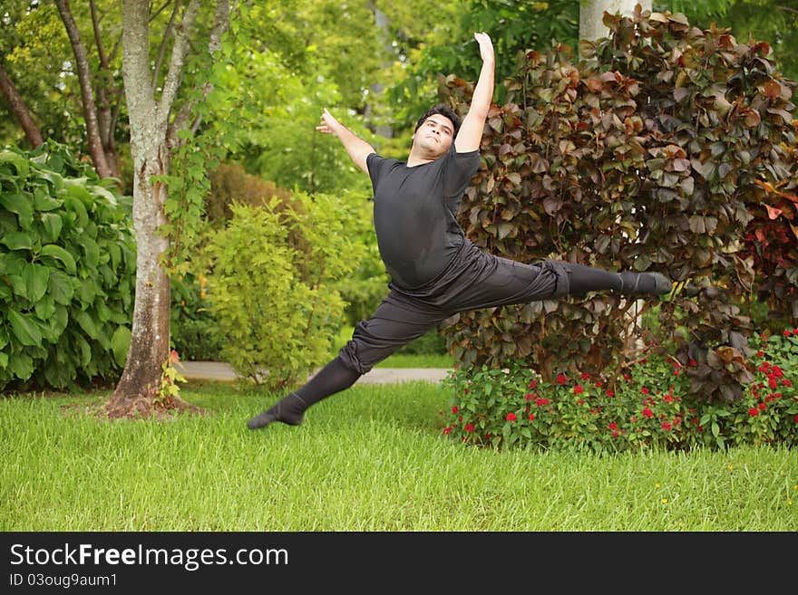 Male ballerina dancing in the park