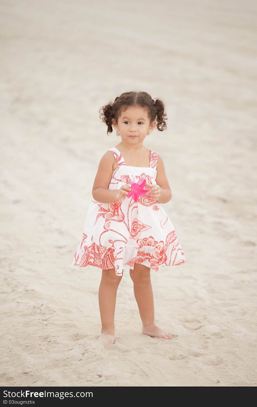 Image of a stylish toddler on the beach