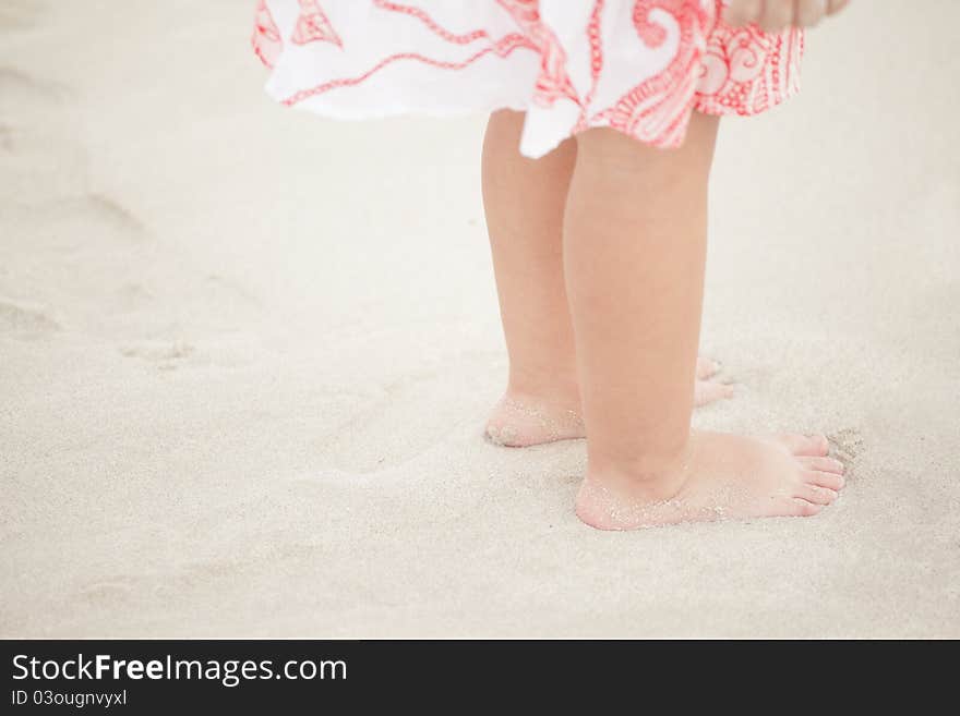 Child feet on the sand