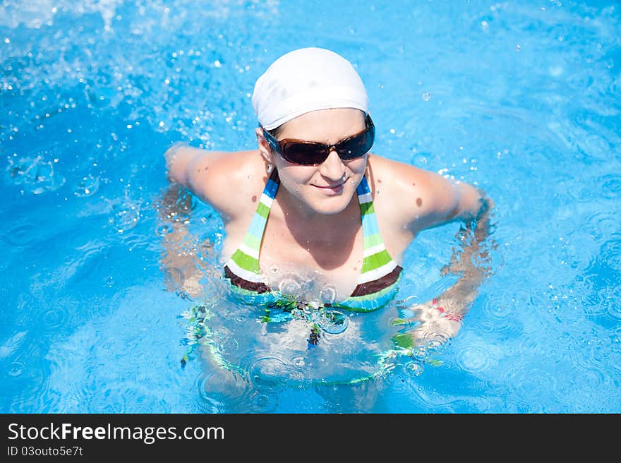 Woman is swimming in pool. Woman is swimming in pool