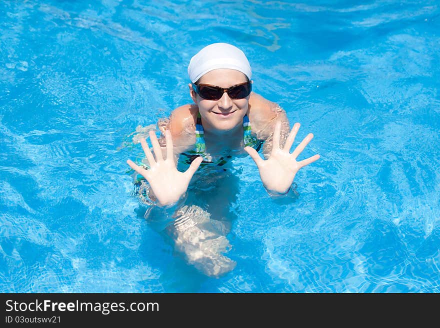 Woman is swimming in pool. Woman is swimming in pool