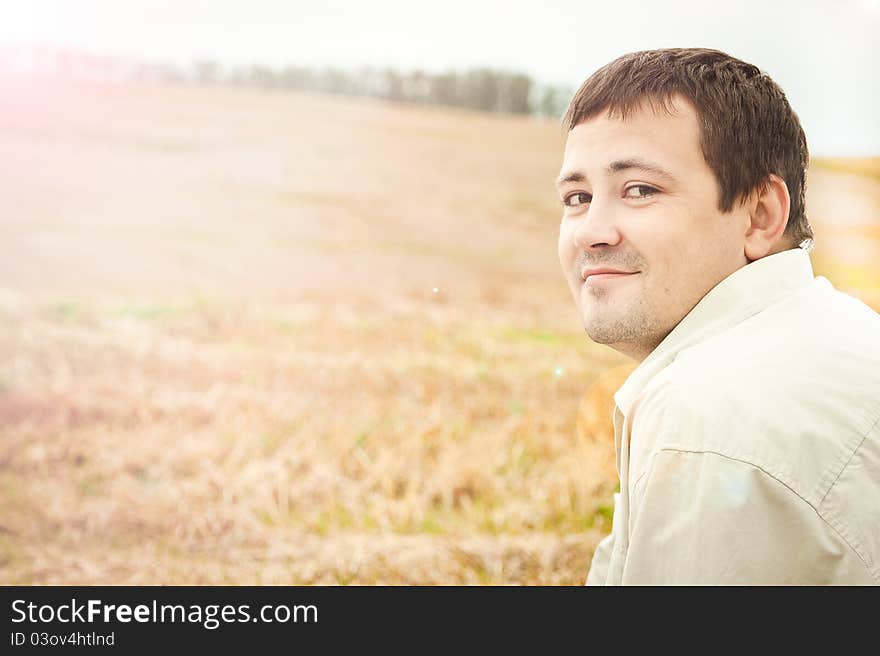 Portrait of the man in the field in solar weather