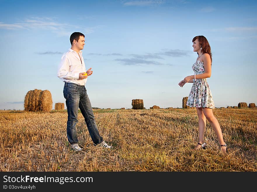 Married couple in the field nearby in solar weather