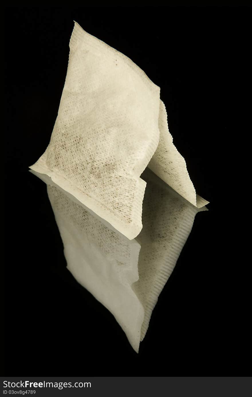 Two white standing tea bags on the black reflecting background. Two white standing tea bags on the black reflecting background