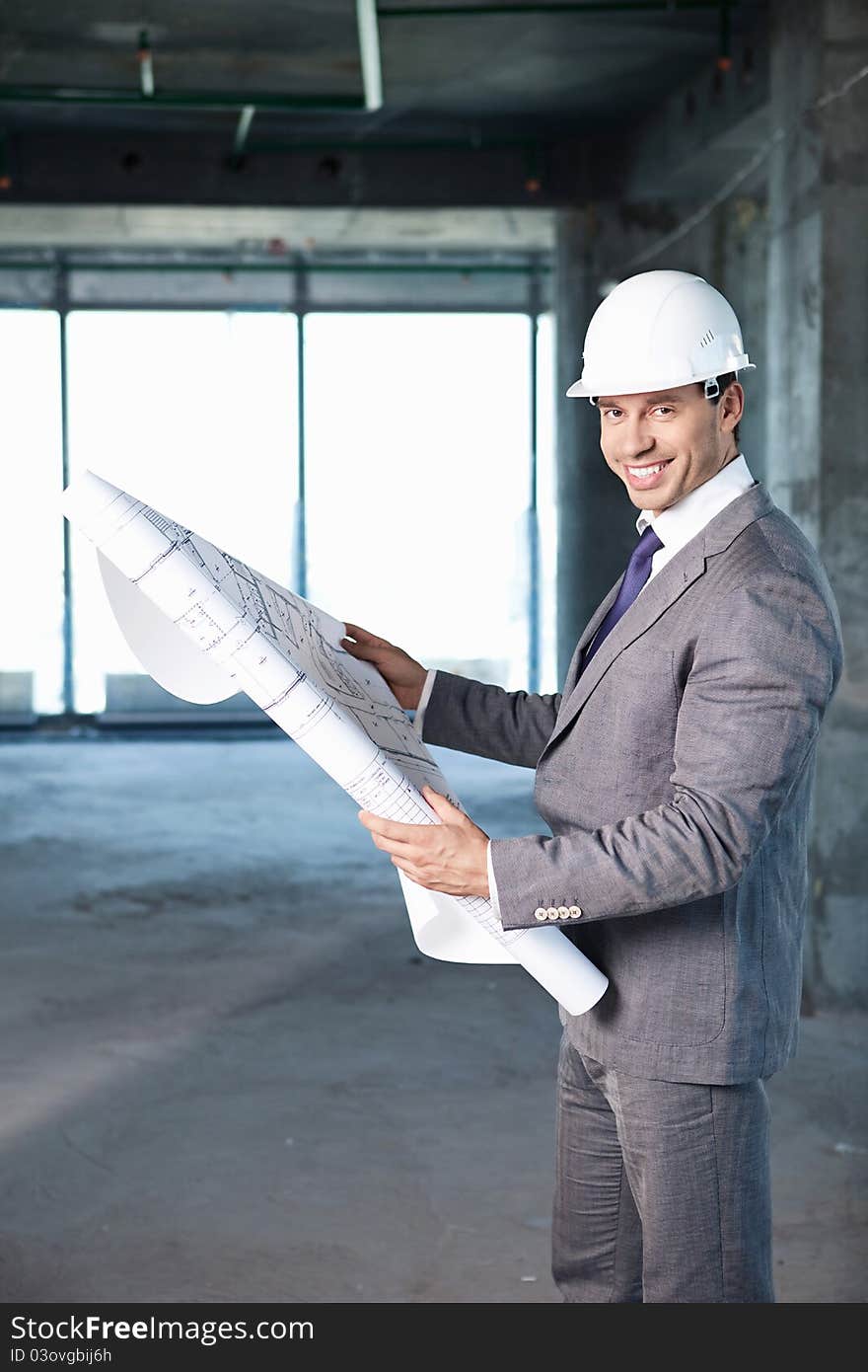 Businessman holding on-site plan. Businessman holding on-site plan