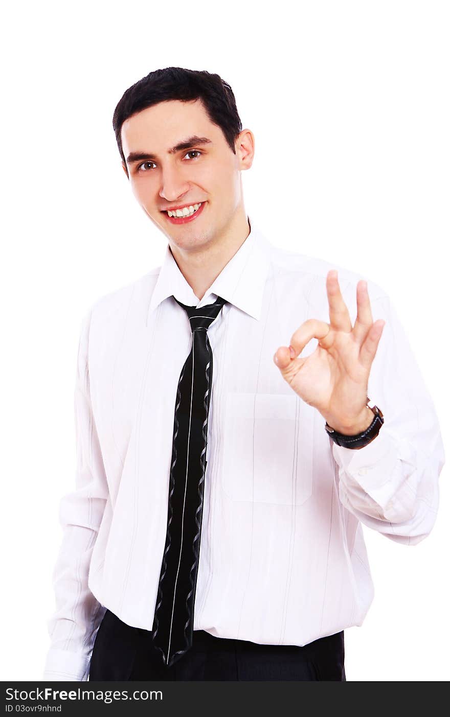 Young smiling businessman showing OK sign isolated over white