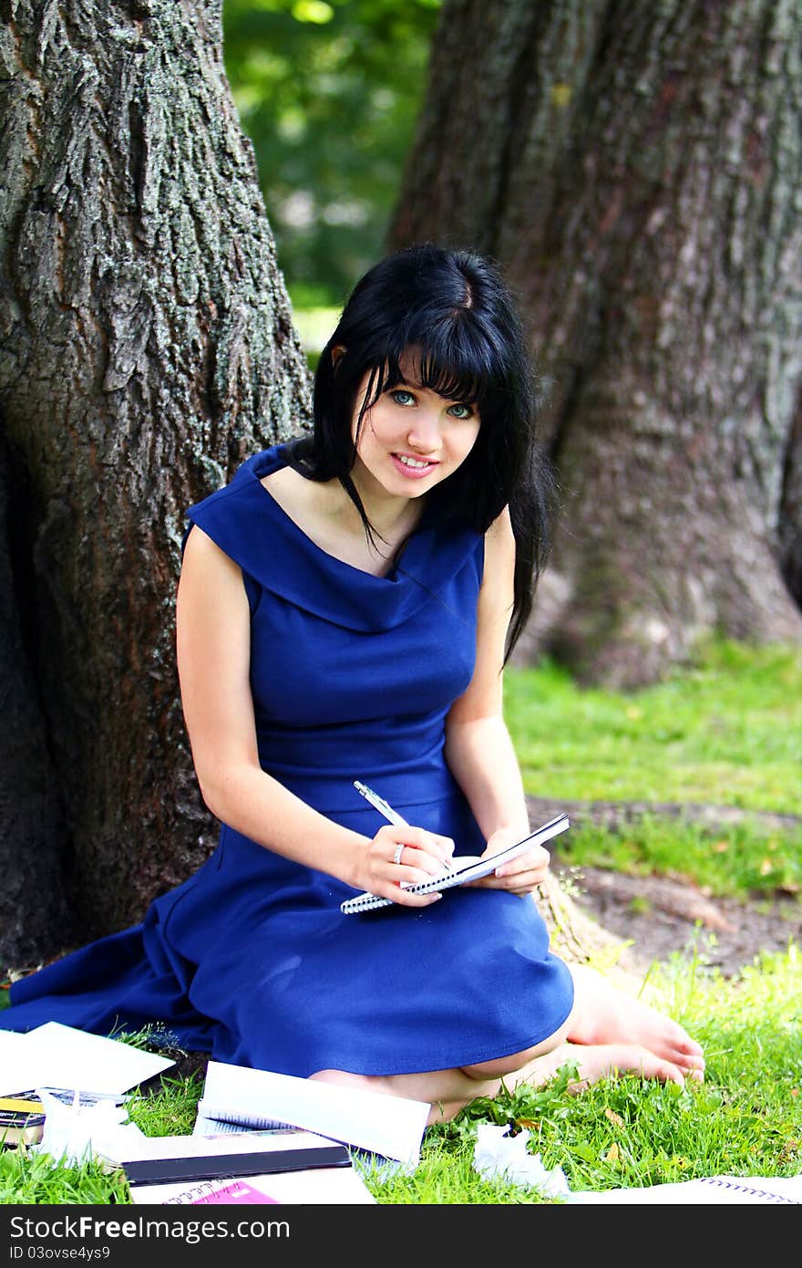 Beautiful Girl Studying In Park