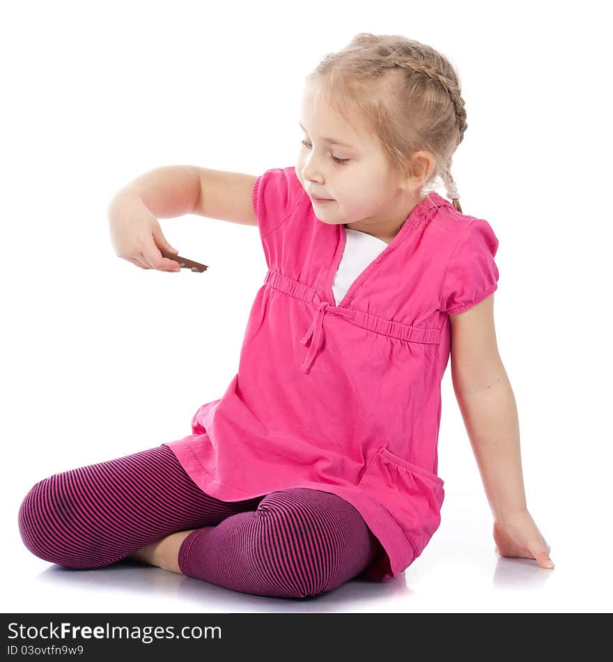 Beautiful girl playing with chocolate bar on white background