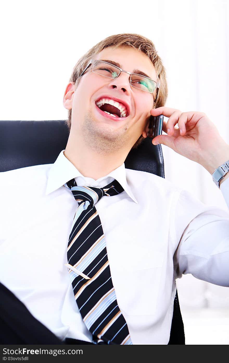 Young Smiling Businessman Using Cell Phone