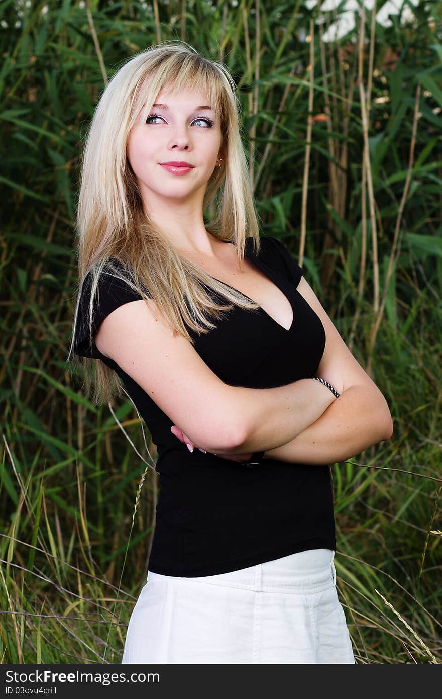 Young attractive blond girl posing outdoors