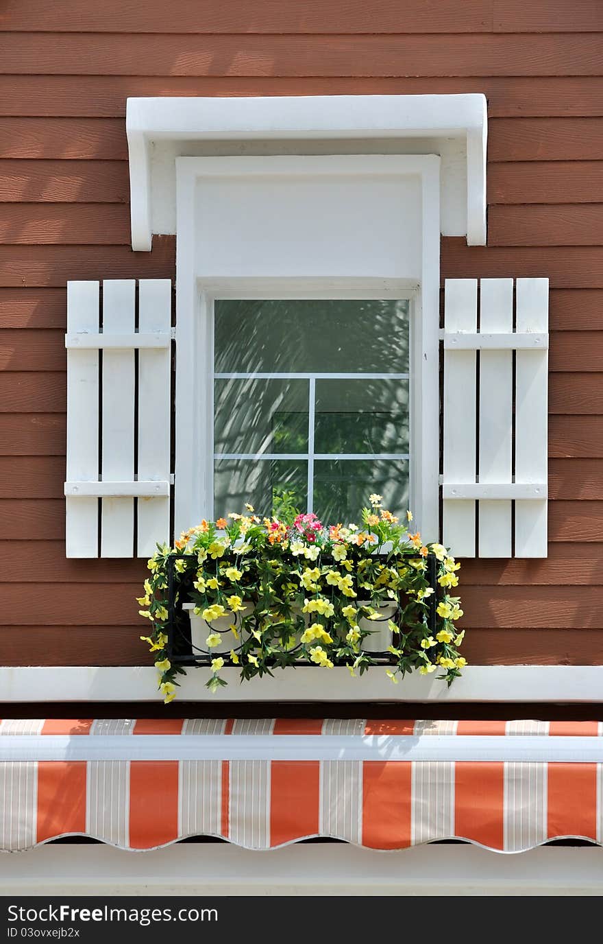 Decorated window in brown wall