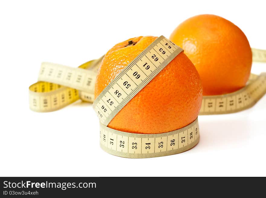 Centimetric tape and an orange on a background on a white background. Centimetric tape and an orange on a background on a white background