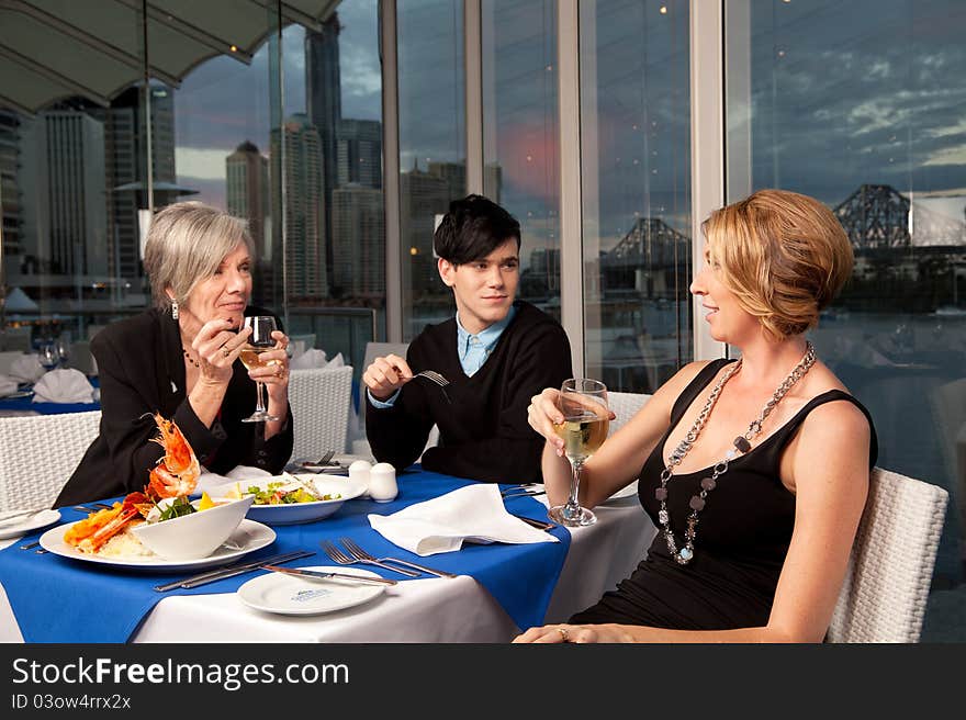 A group of people enjoying a meal. A group of people enjoying a meal