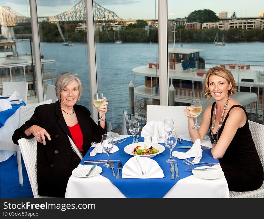 Two women enjoying a lunch with a view. Two women enjoying a lunch with a view