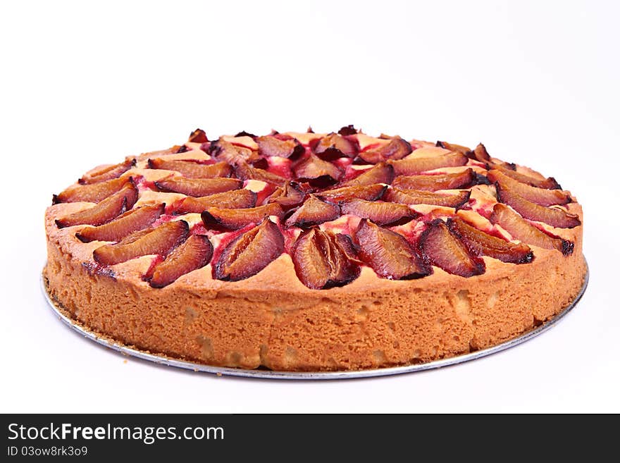 Plum pie on a white background