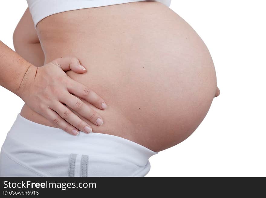 Pregnant woman hold hands on a side of belly isolated