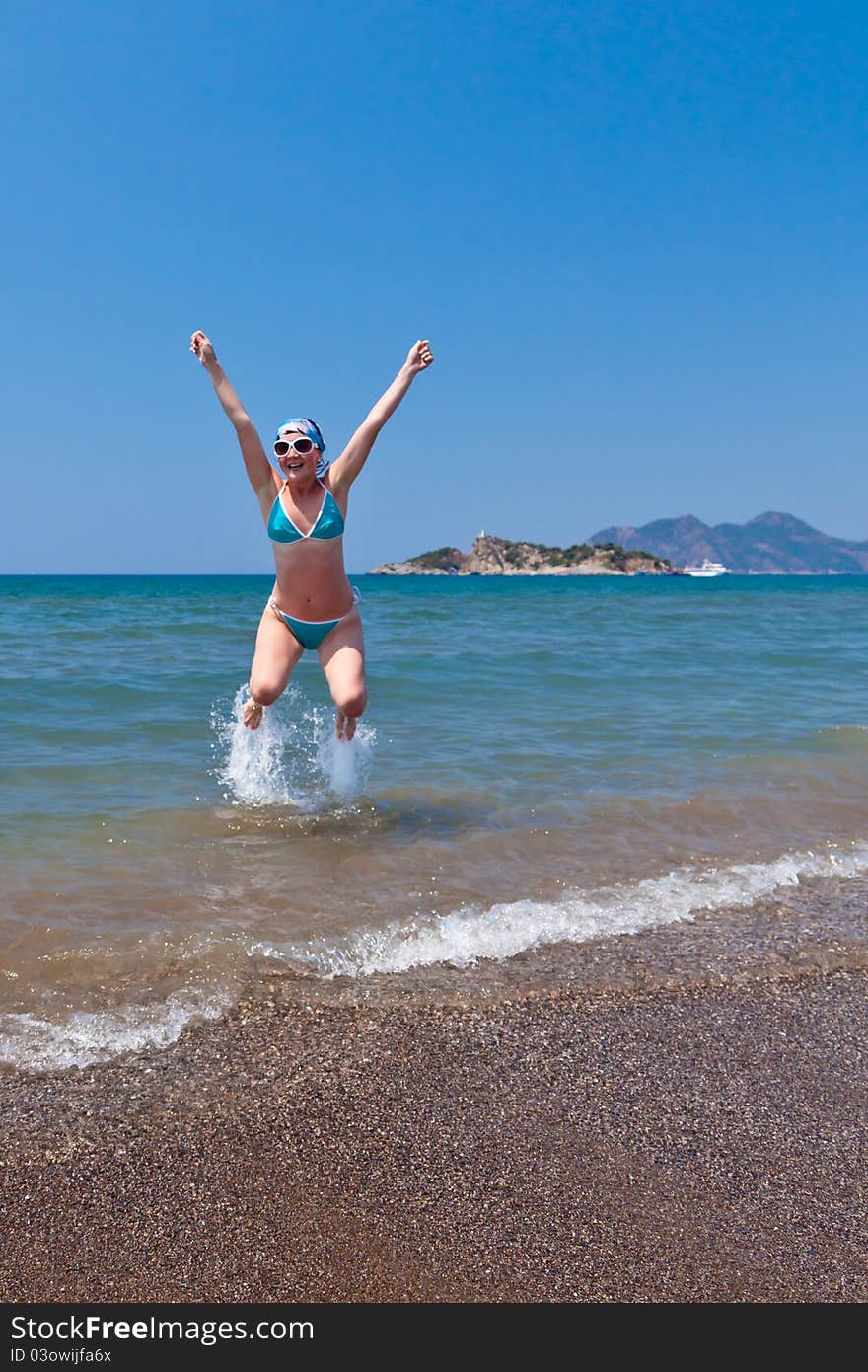 Beautiful young woman having fun on the beach. Beautiful young woman having fun on the beach