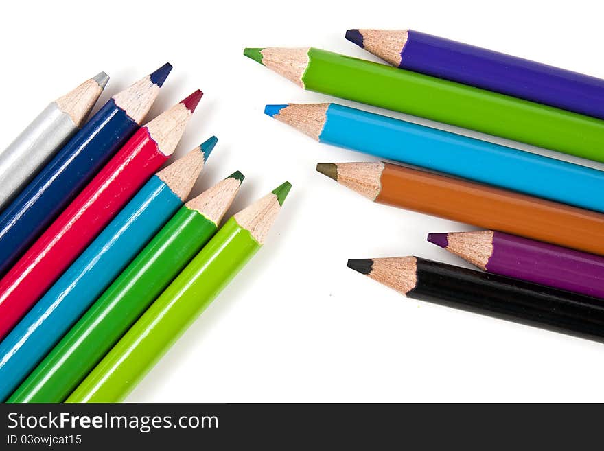 Color pencils in arrange in color wheel colors on white background