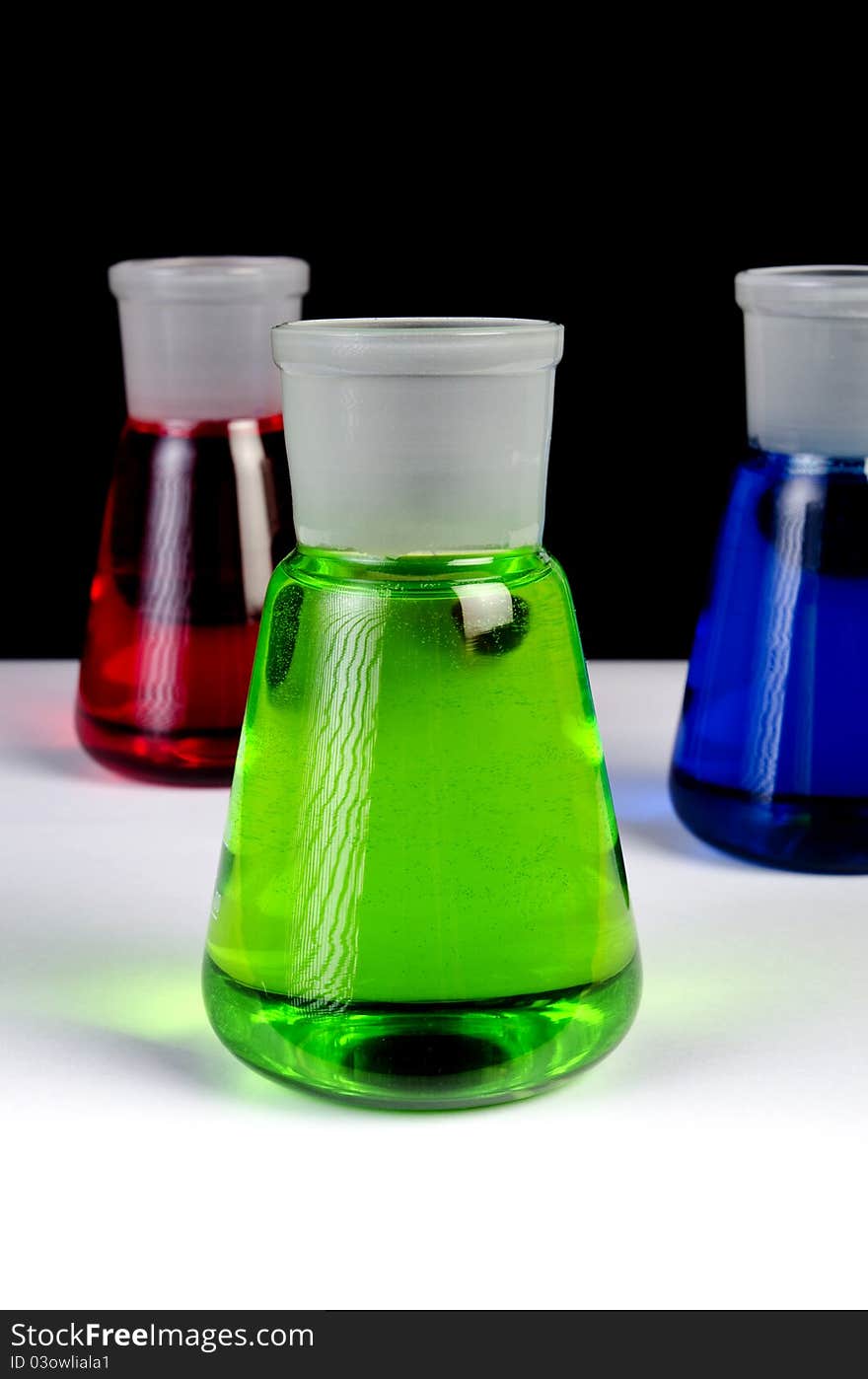 Chemicals in Laboratory Glassware on Black