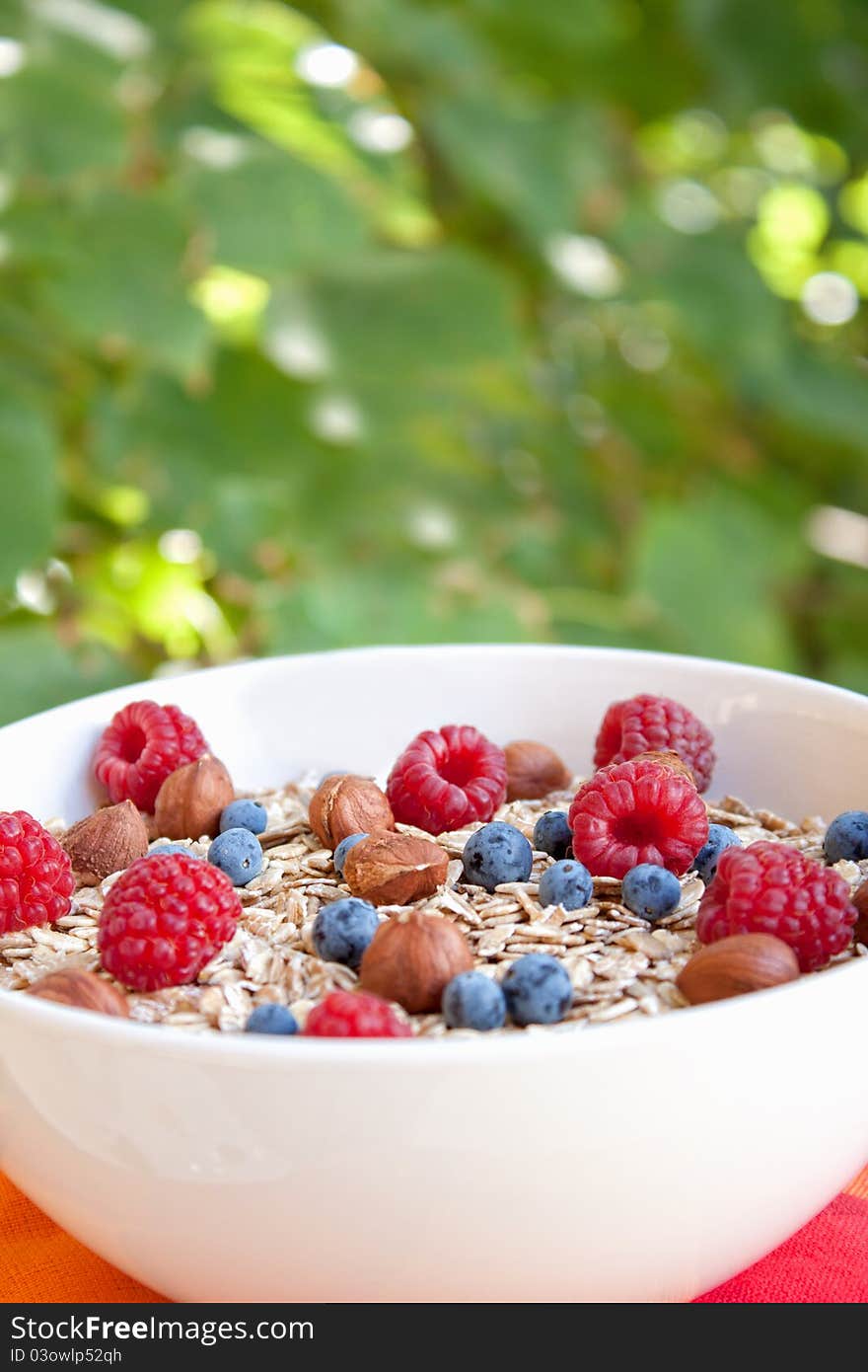 Oat nuts with fresh blueberries and raspberries and hazelnuts. Oat nuts with fresh blueberries and raspberries and hazelnuts