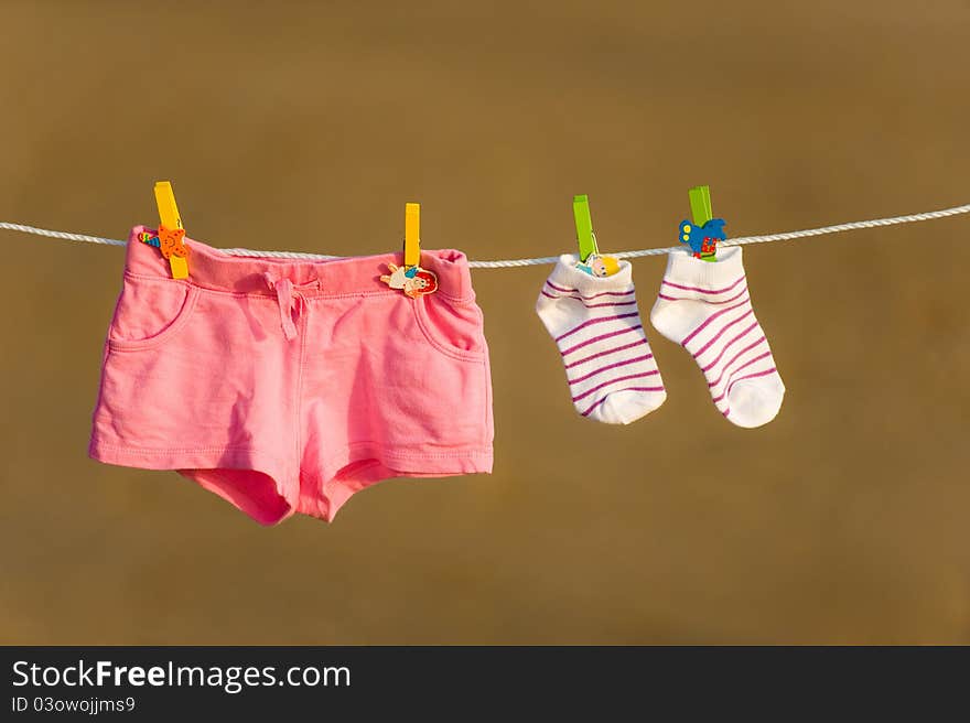 Shorts and socks are drying on a line with