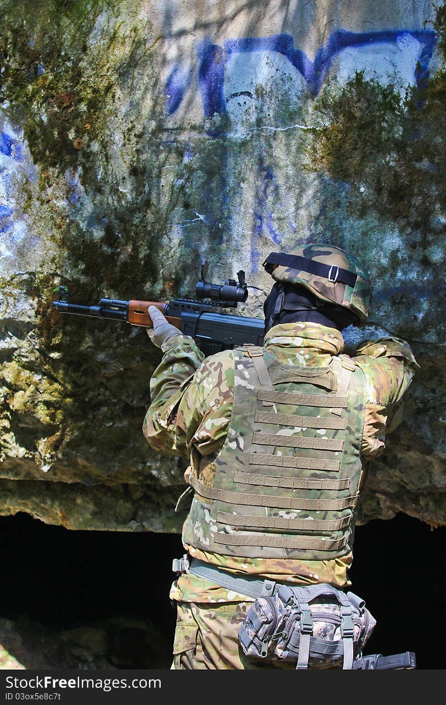 Boy playing with an airsoft gun