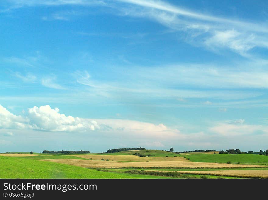 Green meadow sweat dark clouds