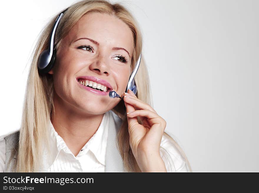 Business woman in a headset on a gray background