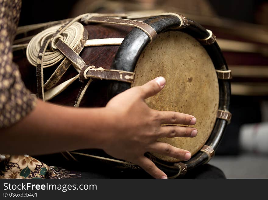 A man playing Thai drum, Thai drum made from wood and skin.