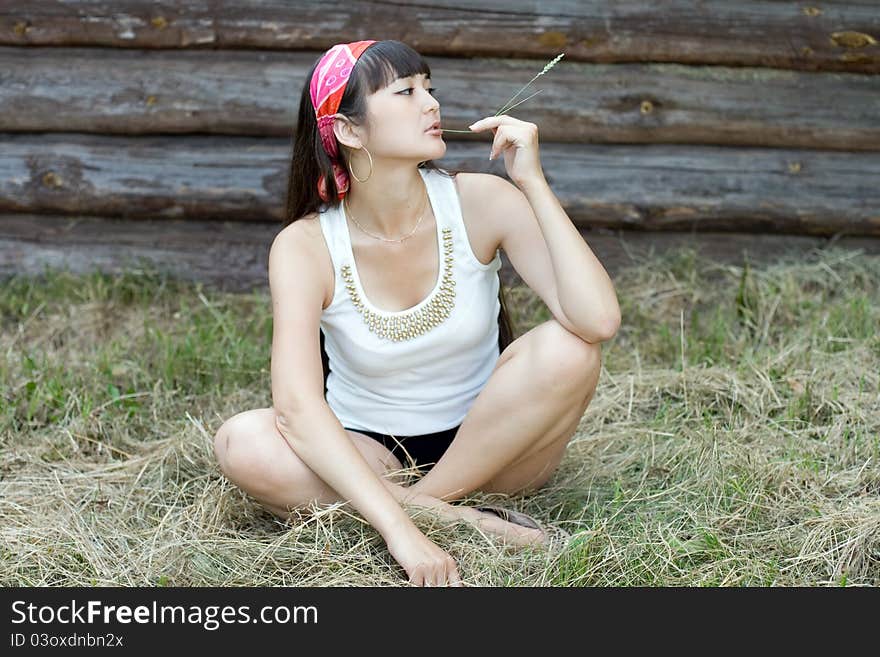 Beautiful girl sitting on hay