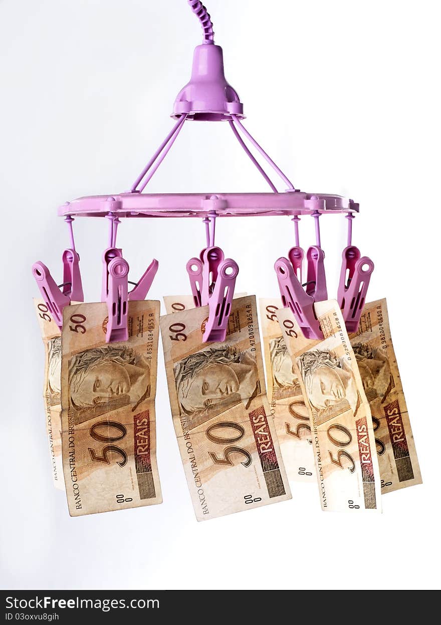 Brazilian bank notes hanging from a washing line. Brazilian bank notes hanging from a washing line