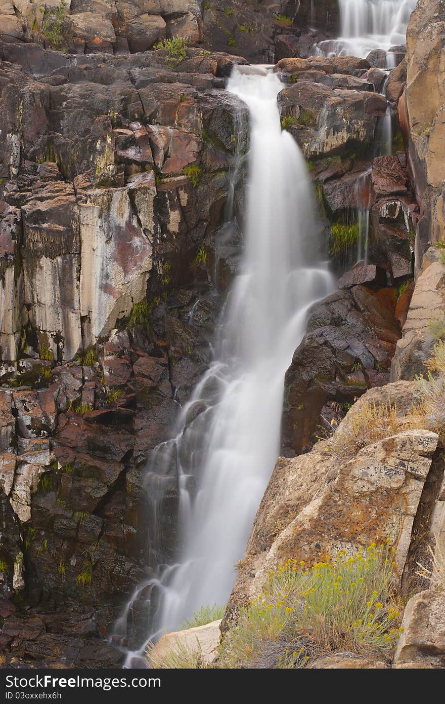 Pretty alpine waterfall in Northern California with motion blurred water cascade. Pretty alpine waterfall in Northern California with motion blurred water cascade