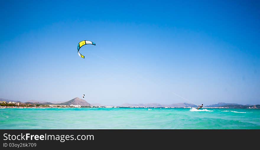 A kitesurfer on a beautiful beach in Spain. A kitesurfer on a beautiful beach in Spain