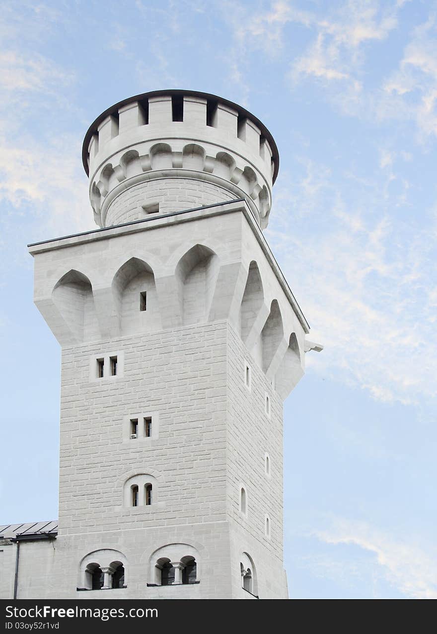 Tower of Neuschwanstein castle in Bavaria over beautiful blue sky