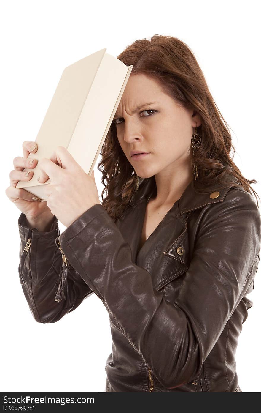 A woman not happy with her book slamming it up against her head. A woman not happy with her book slamming it up against her head.