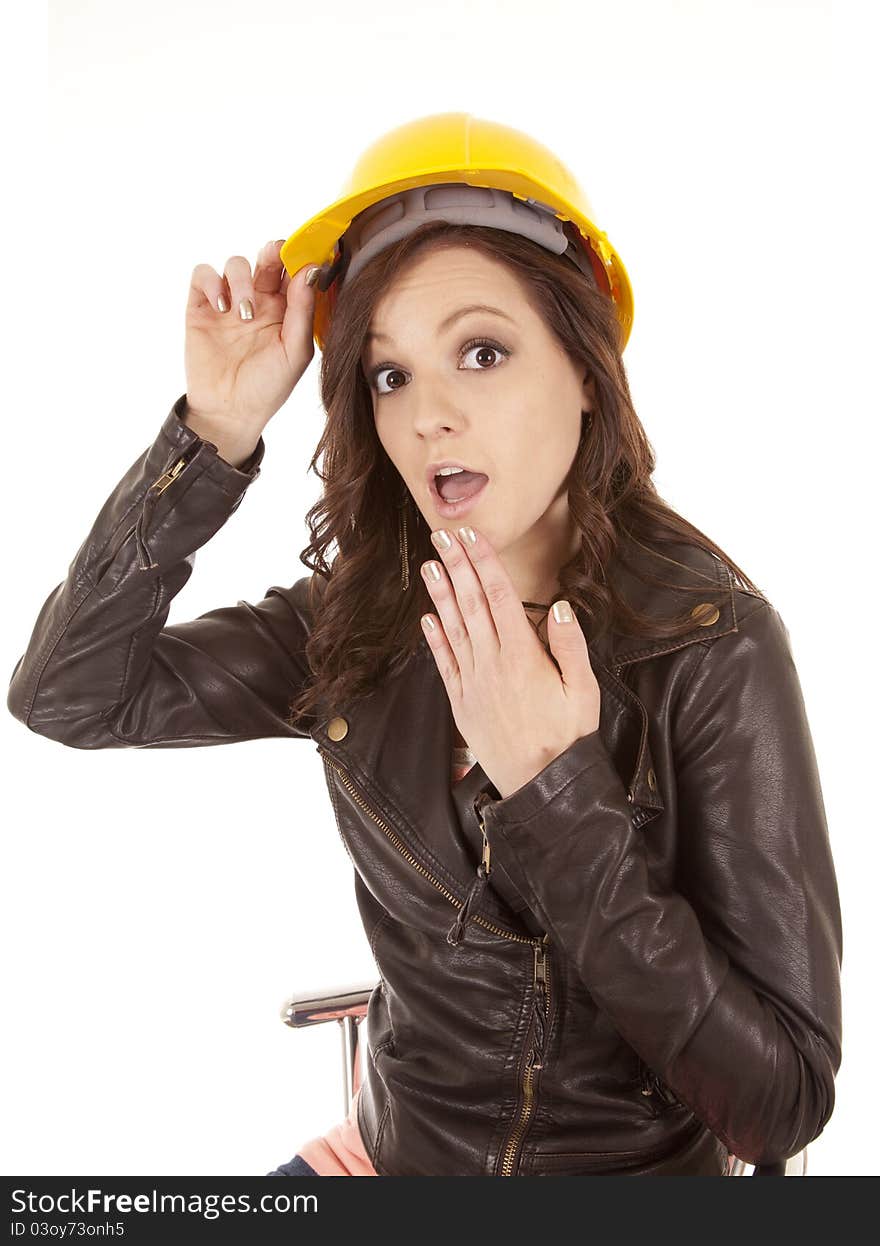 A woman in her yellow construction hat with a shocked expression on her face. A woman in her yellow construction hat with a shocked expression on her face.